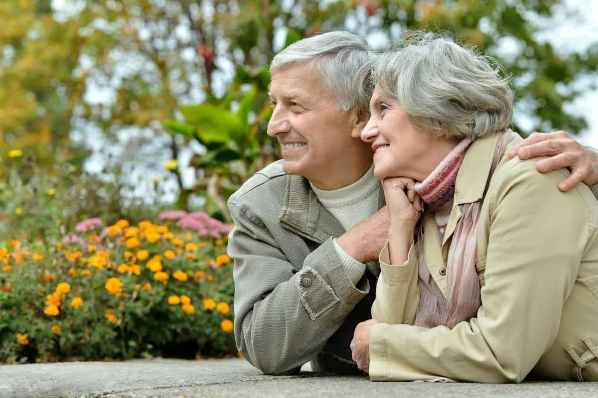 Senior couple relaxing together in an autumn garden