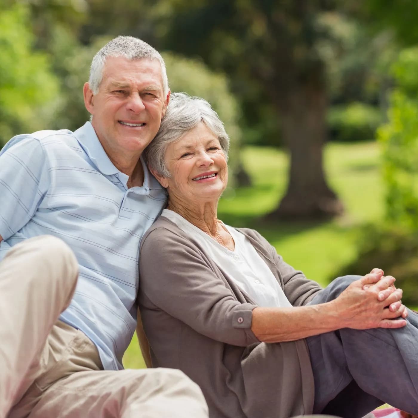 Senior couple seated together outside